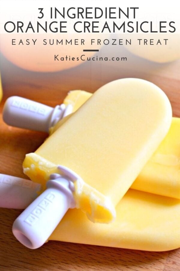 One orange popsicle laying on top of two other popsicles with text on image for Pinterest.