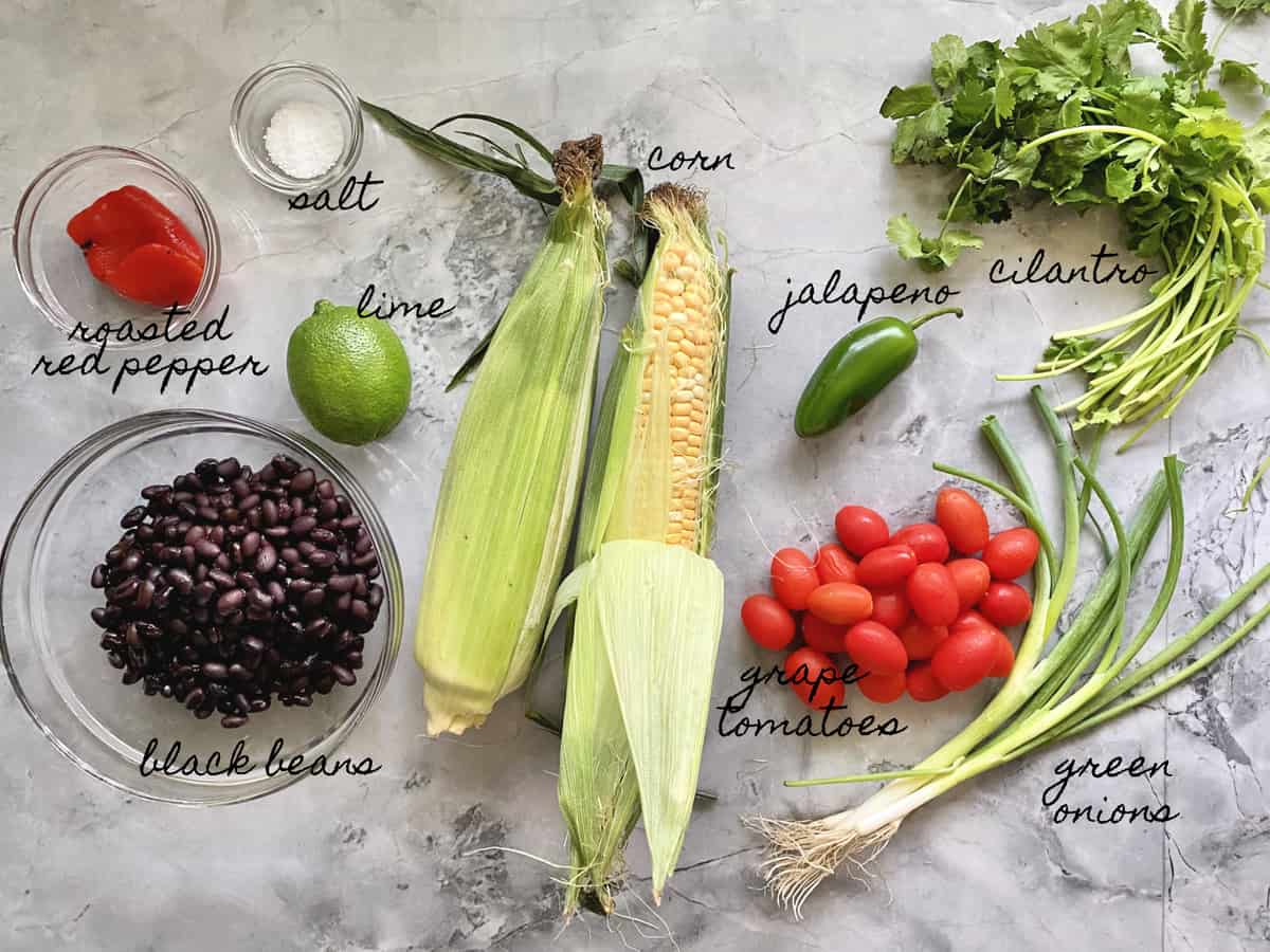 Roasted Red Pepper, salt, lime, black beans, corn, jalapeno, tomatoes, cilantro, and green onions. 