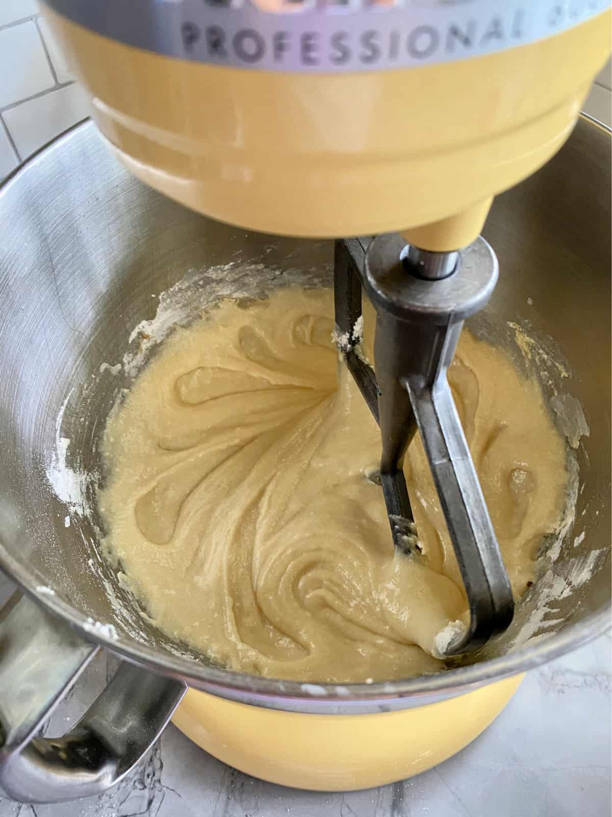 Top view of whipped batter in a KitchenAid Stand Mixer bowl with a paddle attachment.