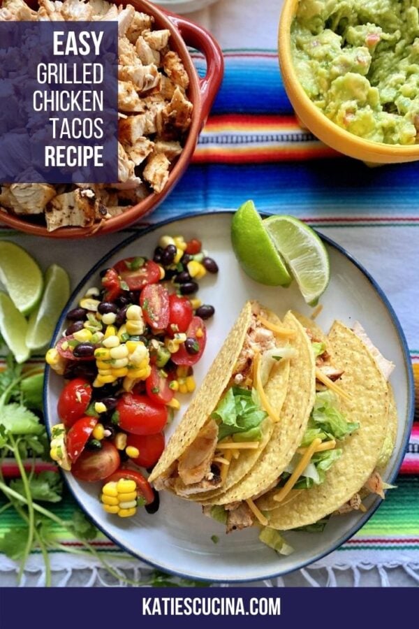 Top view of a plate of three hard shell tacos with black bean salad with text on image for Pinterest.