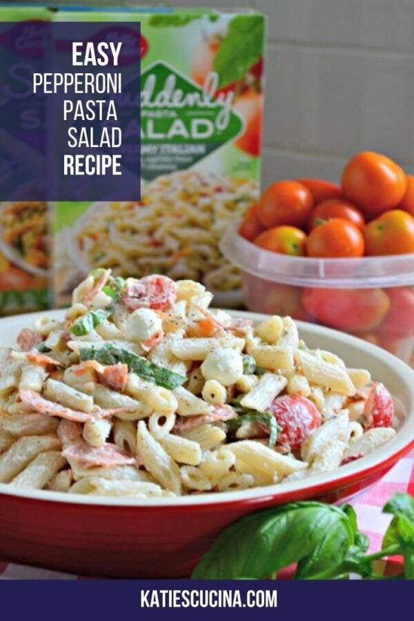 Red dish filled with creamy penne pasta salad text on image for Pinterest.