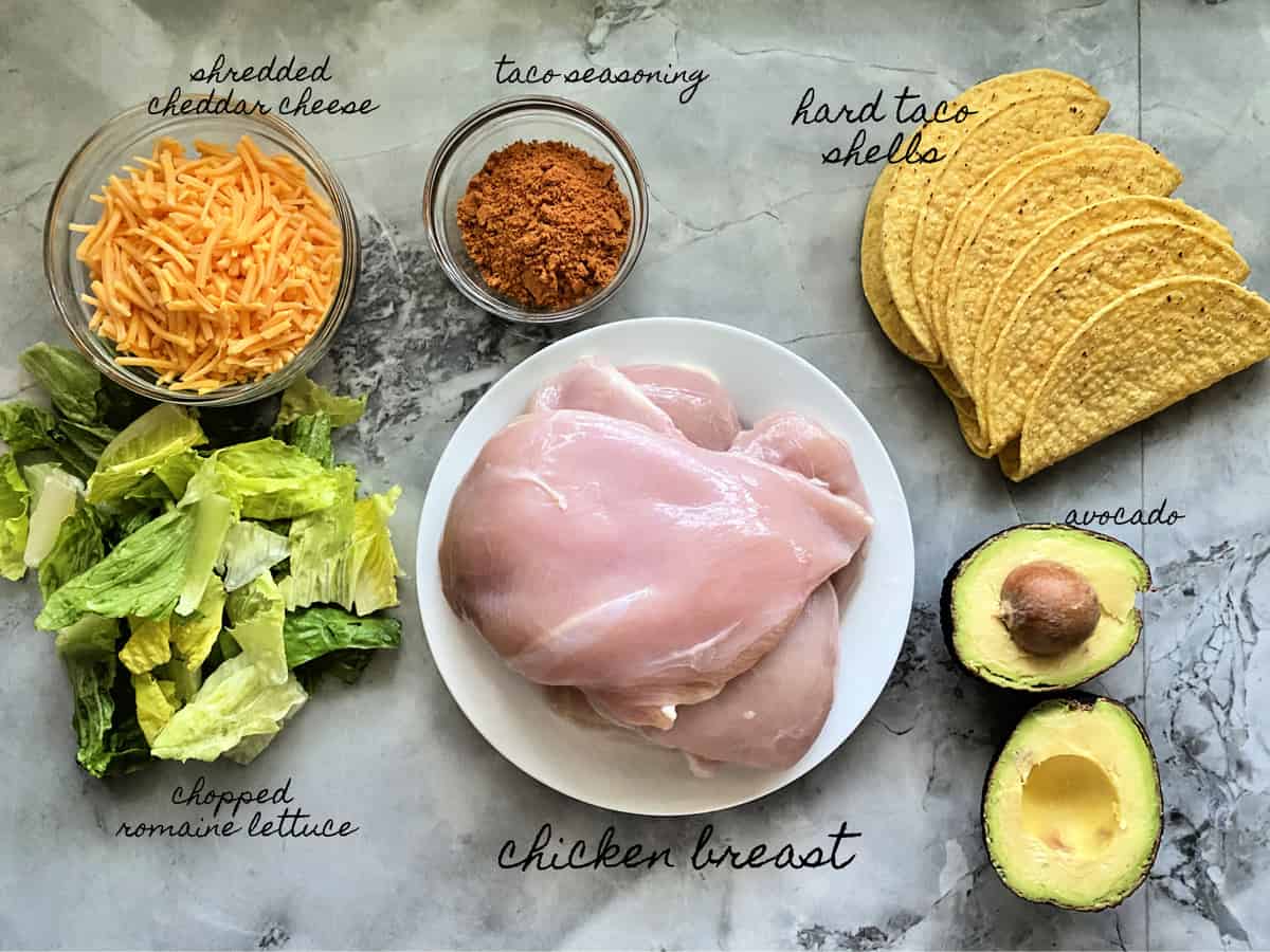 Ingredients: shredded cheddar, lettuce, taco seasoning, taco shells, chicken, avocado.