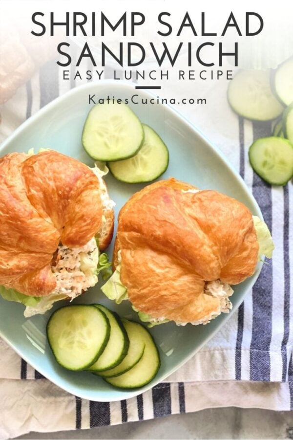 Top view of two croissants filled with shrimp salad sitting on a blue plate with text on image for Pinterest.