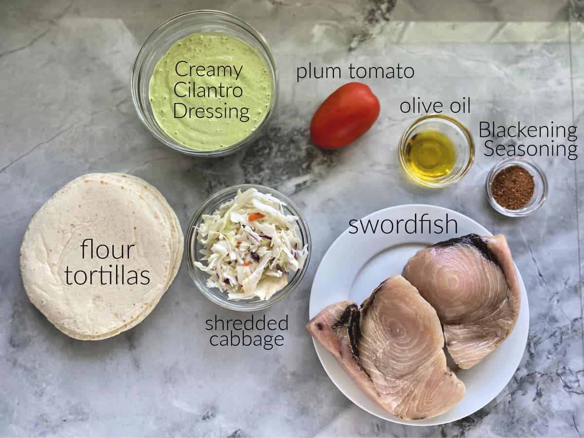 Ingredients: tortillas, shredded cabbage, cilantro dressing, plum tomato, oil, swordfish, blackening seasoning.