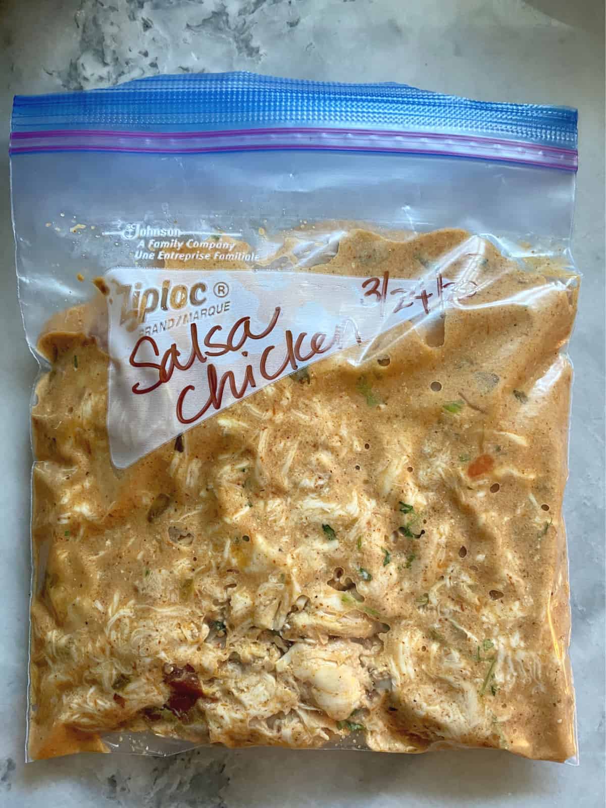 Quart size Ziploc bag labeled and fileld with Salsa chicken with date on bag.