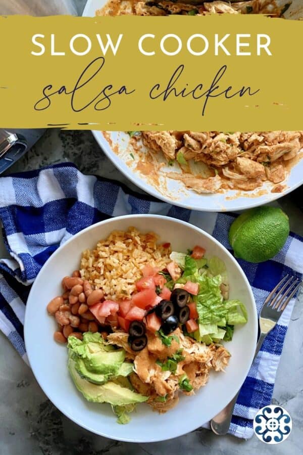 Overhead photo of white bowl with rice, beans, shredded chicken and lettuce.