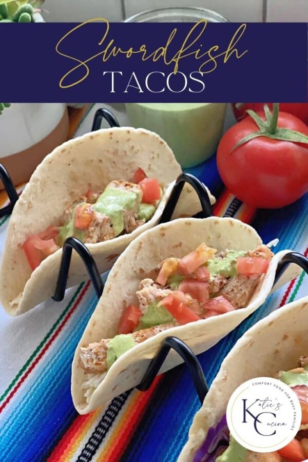 Two soft tacos on a black stand filled with fish with text on image for Pinterest.