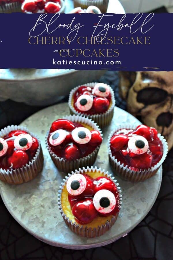 Cherry cheesecake cupcakes with candy eyeballs on them with text on image for Pinterest.