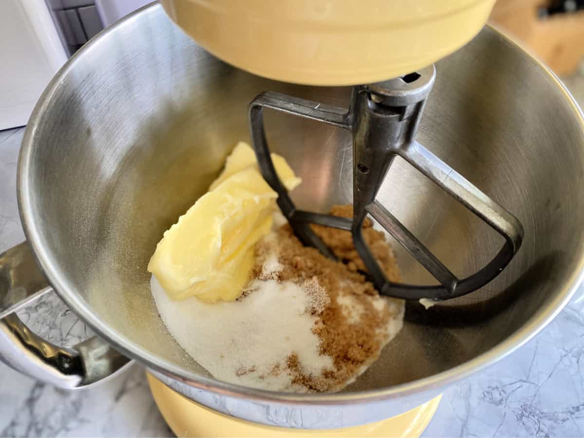 Top view of a mixing bowl with butter and sugar.