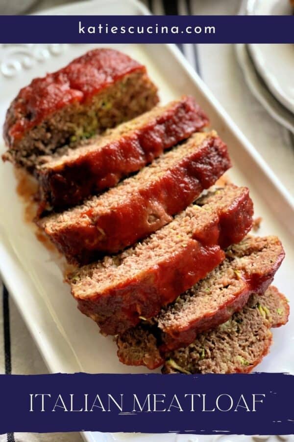 Top view of sliced meatloaf on a white platter with text on image for Pinterest.