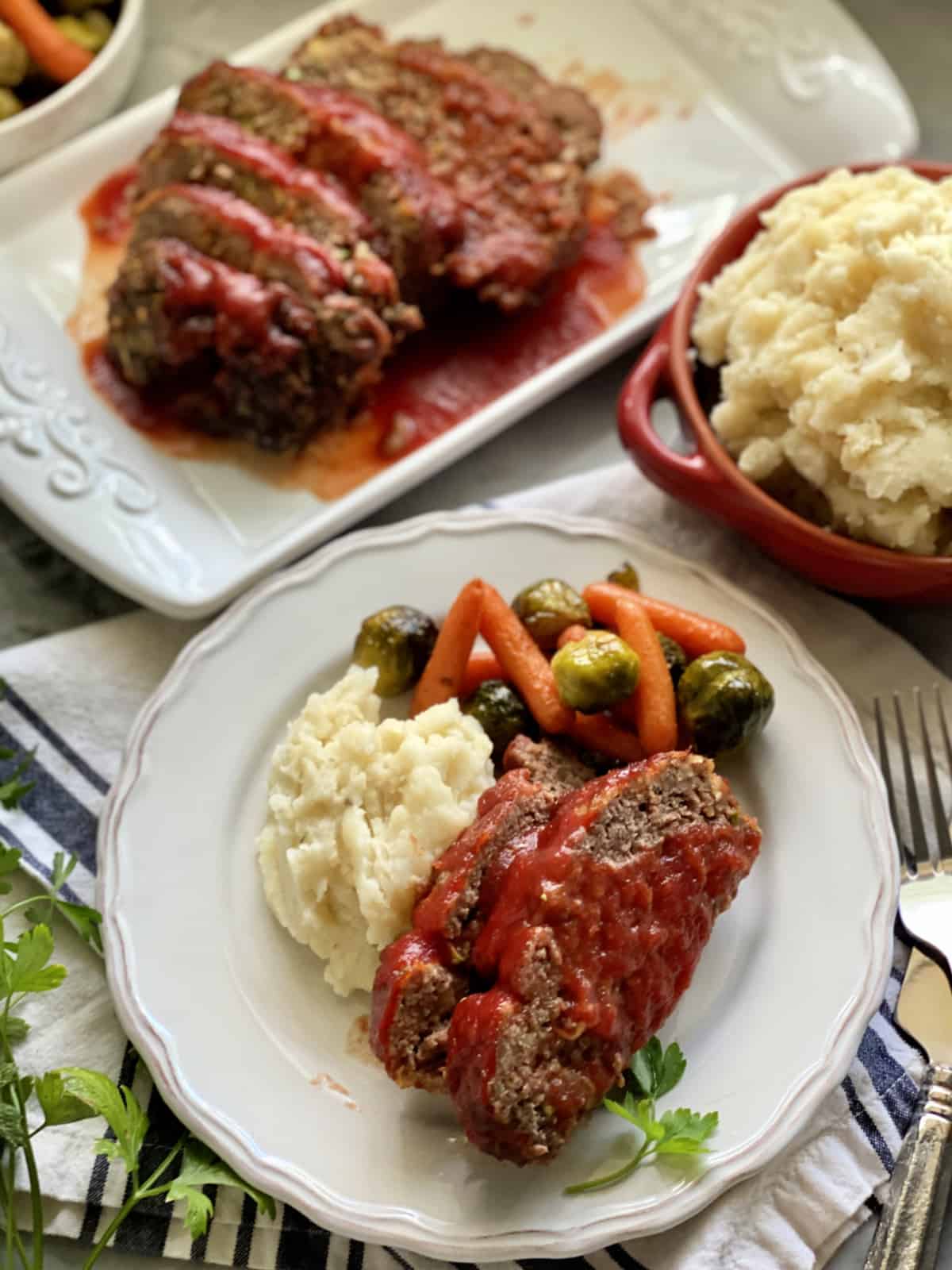 Top view of a plate of meatloaf with mashed potatoes.