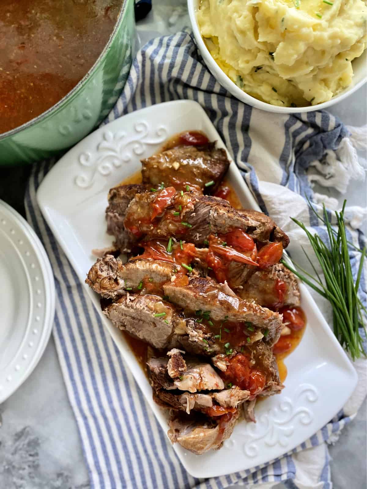 Top view of a sliced pork roast on a white platter.