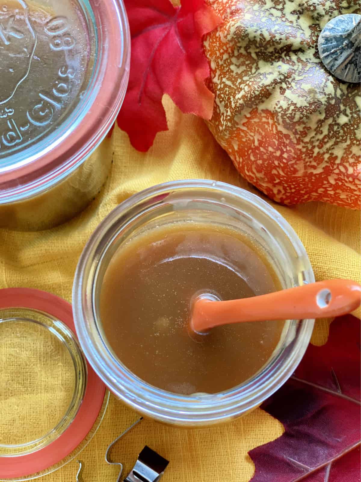 Top view of an open glass jar filled with caramel sauce.