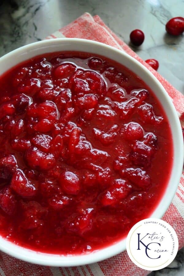 White bowl filled with cranberry sauce with text on image for Pinterest.
