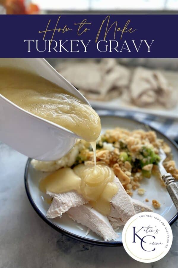 Gravy being poured out of a gravy boat onto a plate of sliced turkey.