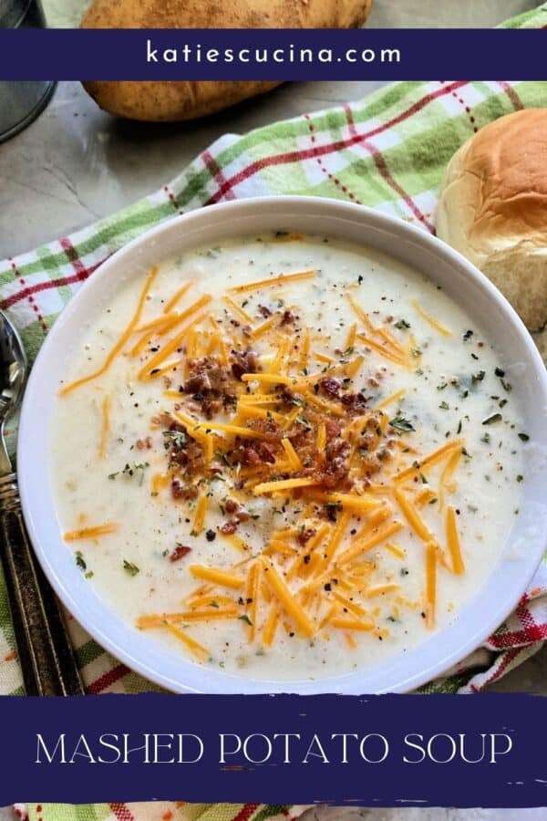 Mashed Potato Soup topped with cheese and bacon in white bowl with text on image for Pinterest.