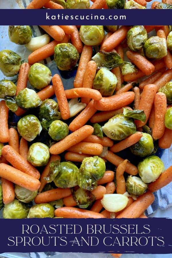 Top view of roasted carrots, brussels sprouts, and garlic with text on image for Pinterest.