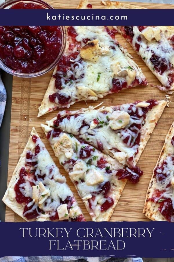 Top view of four triangle slices of flatbread with cranberry sauce on the side.