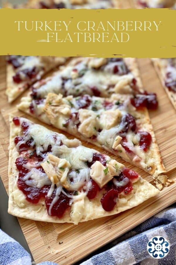 Top view of a flatbread with turkey, mozzarella and cranberry sauce.