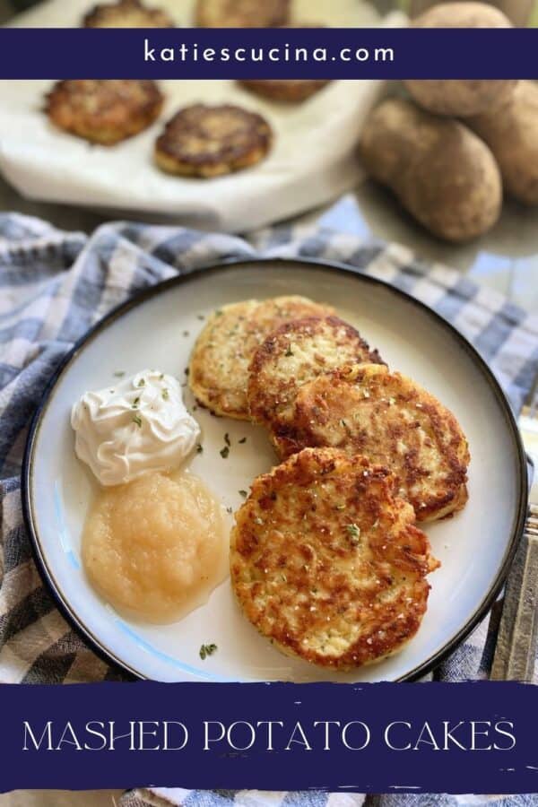 Plate of potato cakes with sour cream and applesauce next to it with text on image for Pinterest.