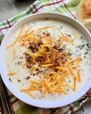 white bowl filled with mashed potato soup.