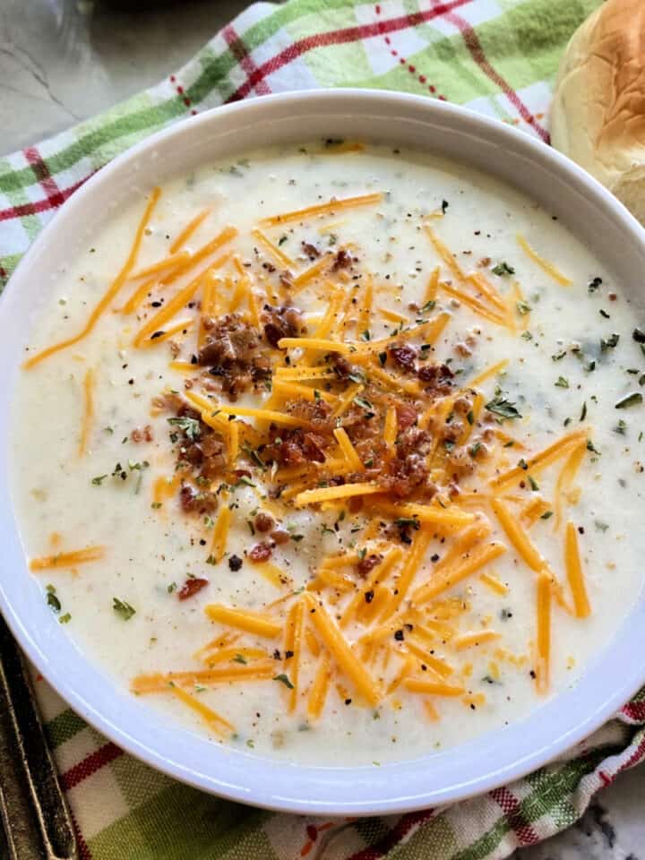 white bowl filled with mashed potato soup.