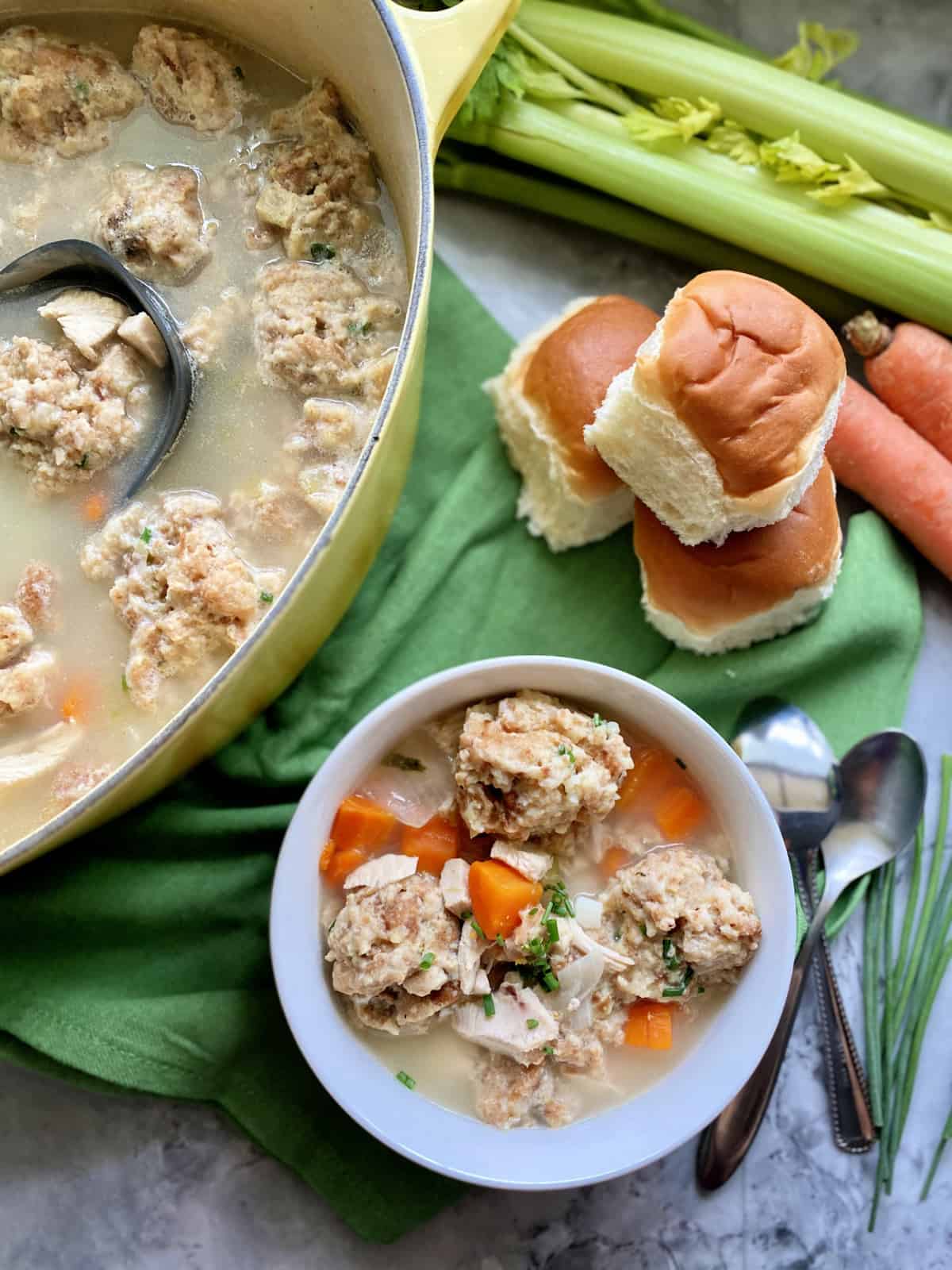 Top view of a pot of stuffing dumpling soup and a bowl sitting right next to it.