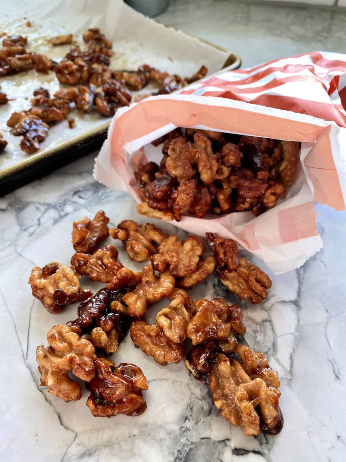 Orange and white striped bag with candied walnuts inside.