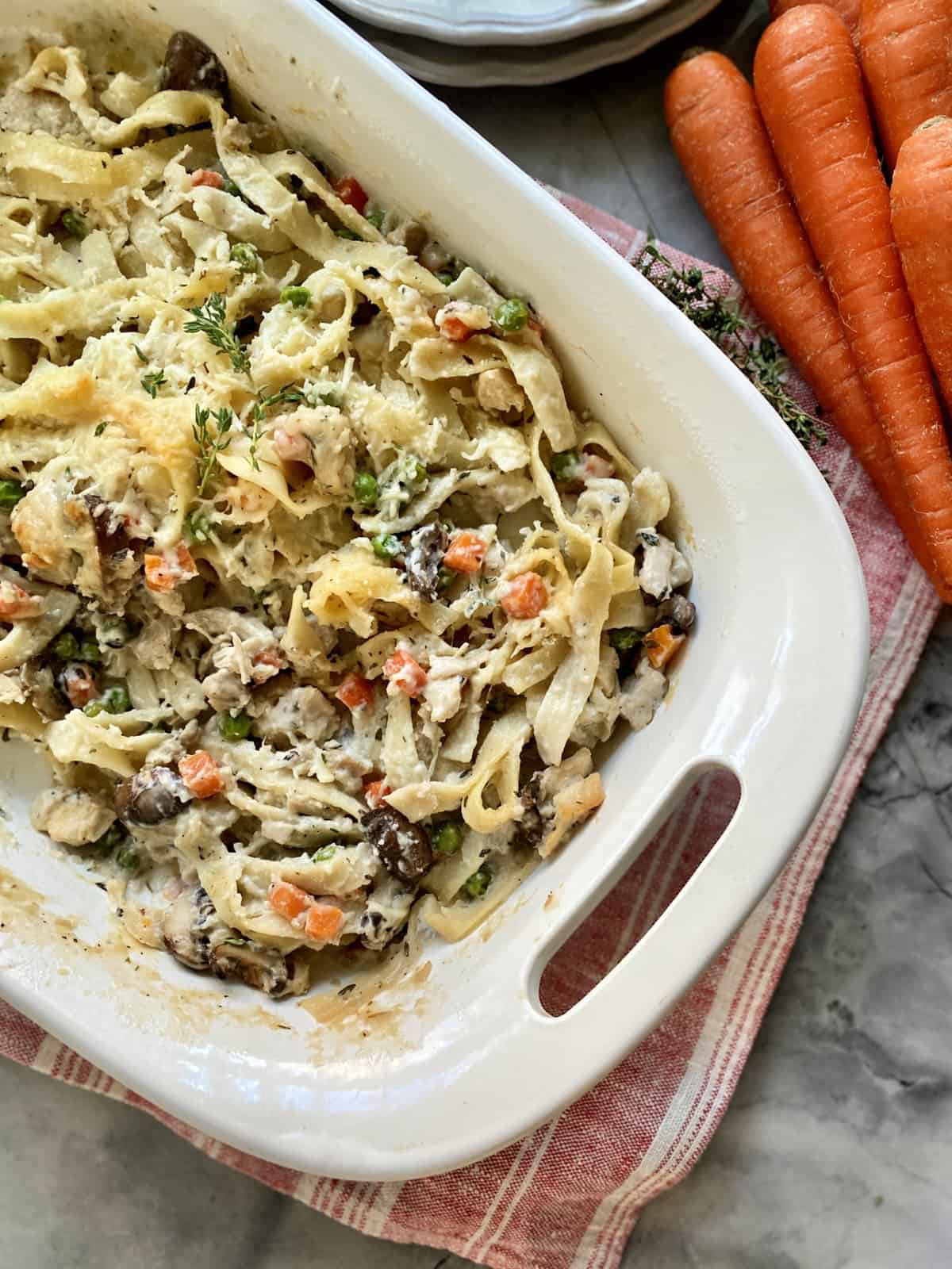 Top view of a casserole dish with baked pasta and vegetables.