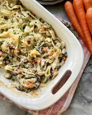 Top view of a casserole dish with baked pasta and vegetables.