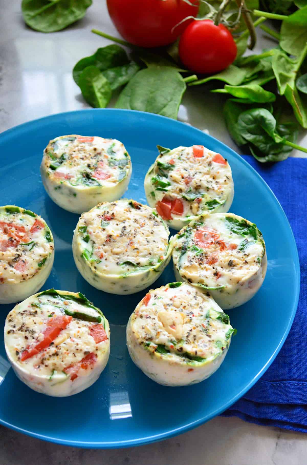 Close up of a blue plate filled with egg white bites