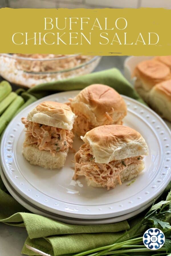 Three sandwiches filled with buffalo chicken salad on two white plates with text on image for Pinterest.