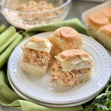 Three King's Hawaiian Rolls filled with shredded chicken on a white plate.