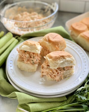 Three King's Hawaiian Rolls filled with shredded chicken on a white plate.