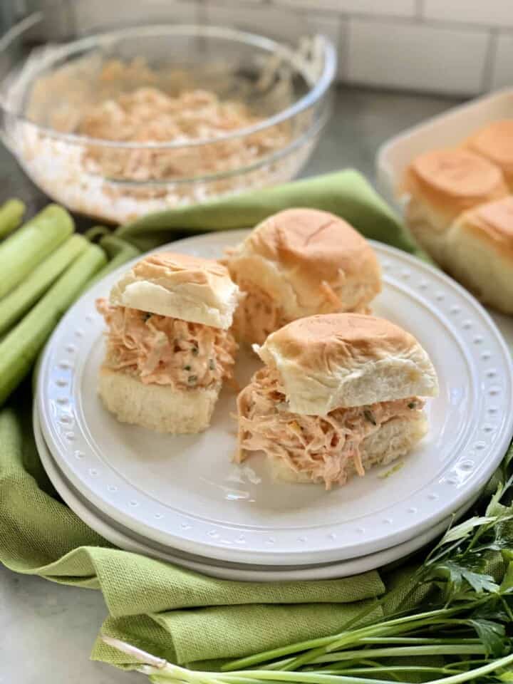 Three King's Hawaiian Rolls filled with shredded chicken on a white plate.