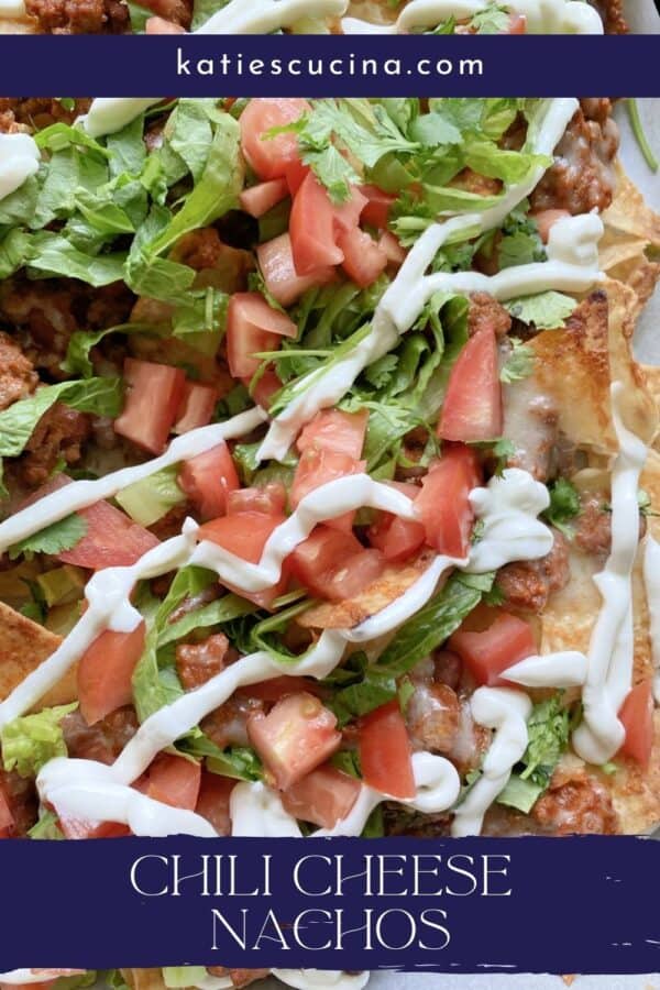 Close up of loaded chili cheese nachos with text on image for Pinterest.