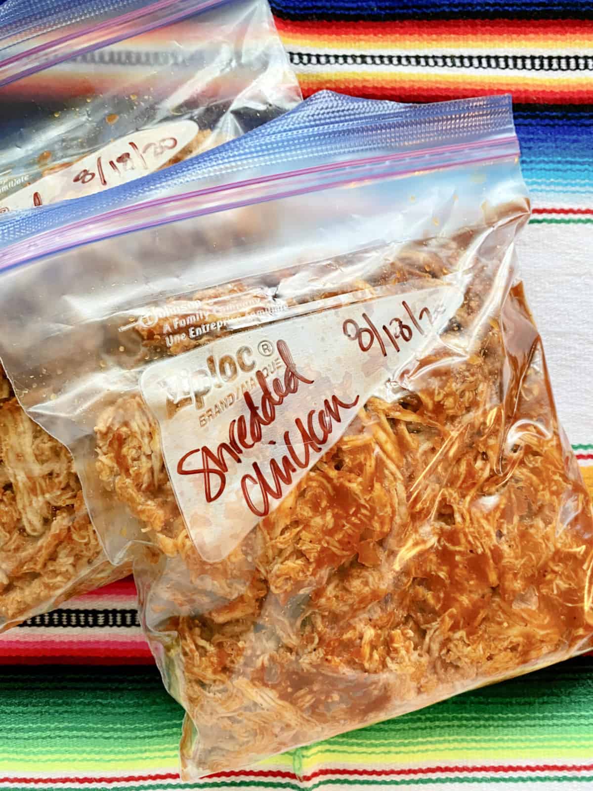 Two quart size bags labeled and filled with shredded chicken.