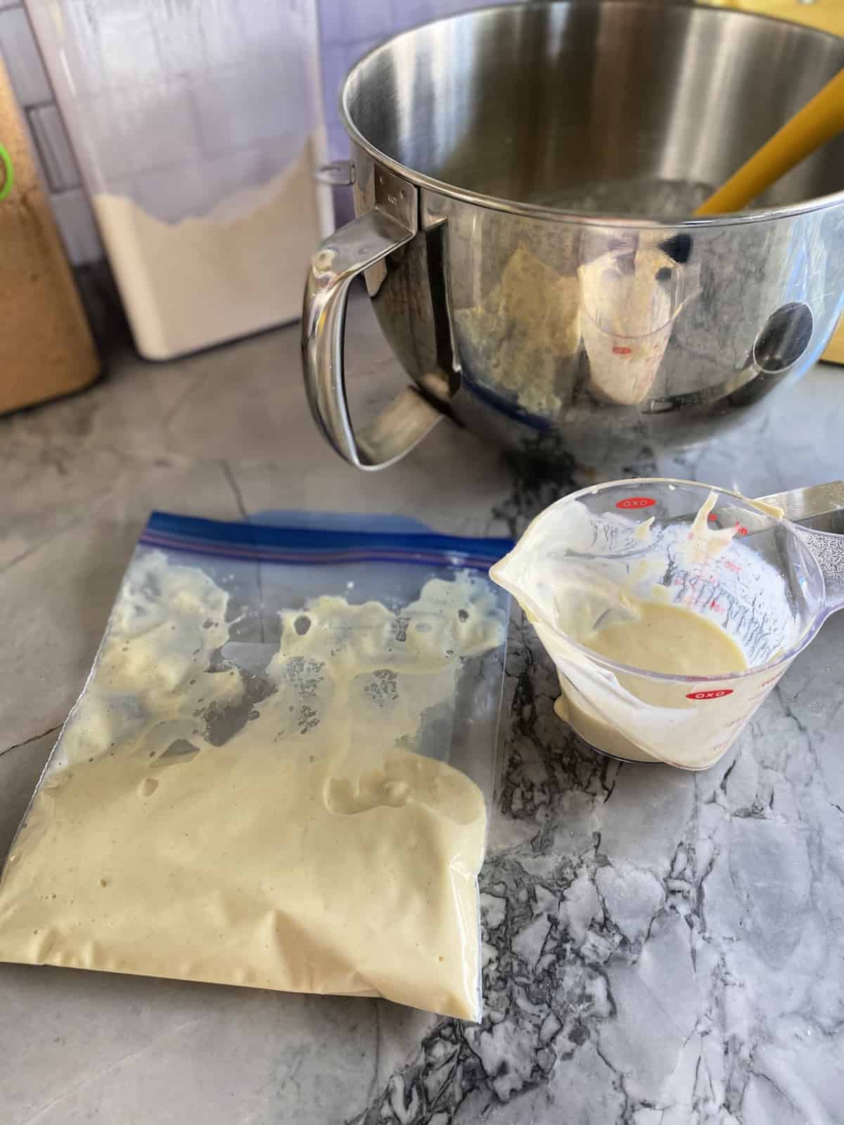 Pancake batter in a ziplock bag and in a measuring cup.