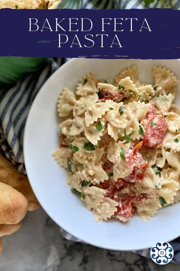 Top view of a bowl of bowtie pasta in cheese and tomato sauce with text on image for Pitnerest.