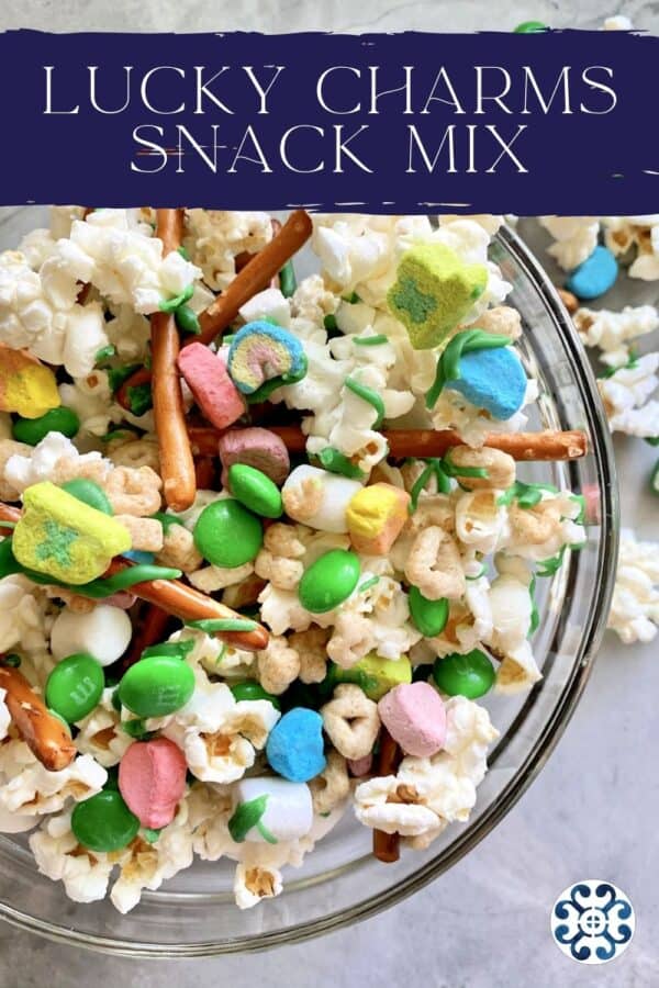 Top view of a glass bowl filled with lucky charms mix with text on image for pinterest.