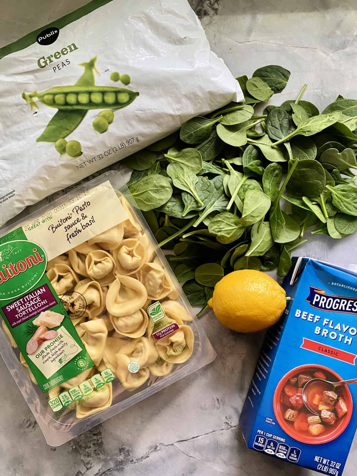 Ingredients: frozen peas, fresh spinach leaves, lemon, beef broth, sausage tortelloni