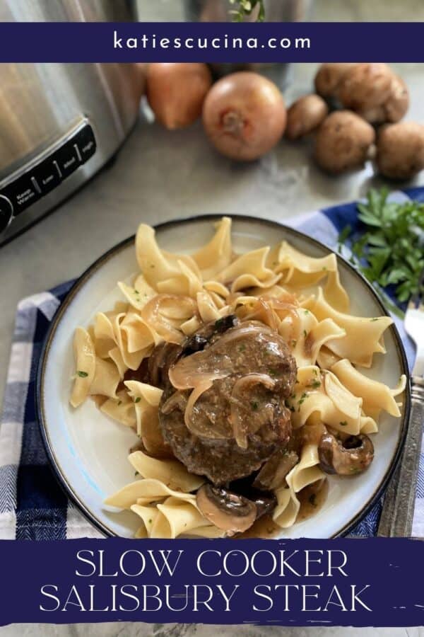 Top view of a white plate filled with egg noodles and hamburger steak with gravy with text on image for Pinterest.