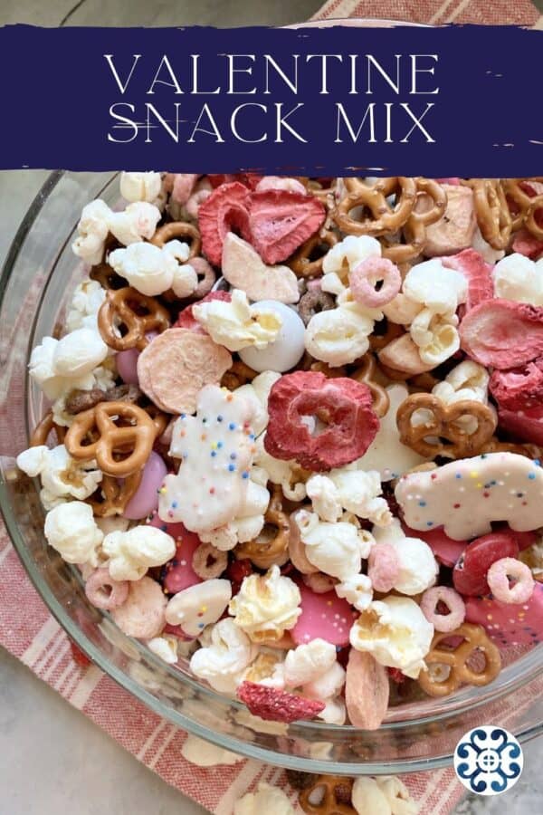 Top view of a glass bowl filled with red, pink, and white snacks with text on image for Pinterest.