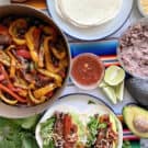 Top view of fajita peppers in a skillet, fajitas on a plate, and tortillas on the side.