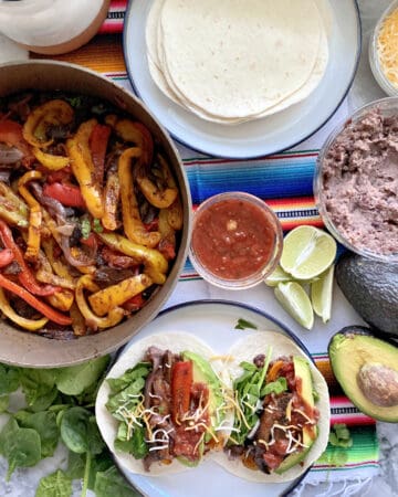 Top view of fajita peppers in a skillet, fajitas on a plate, and tortillas on the side.