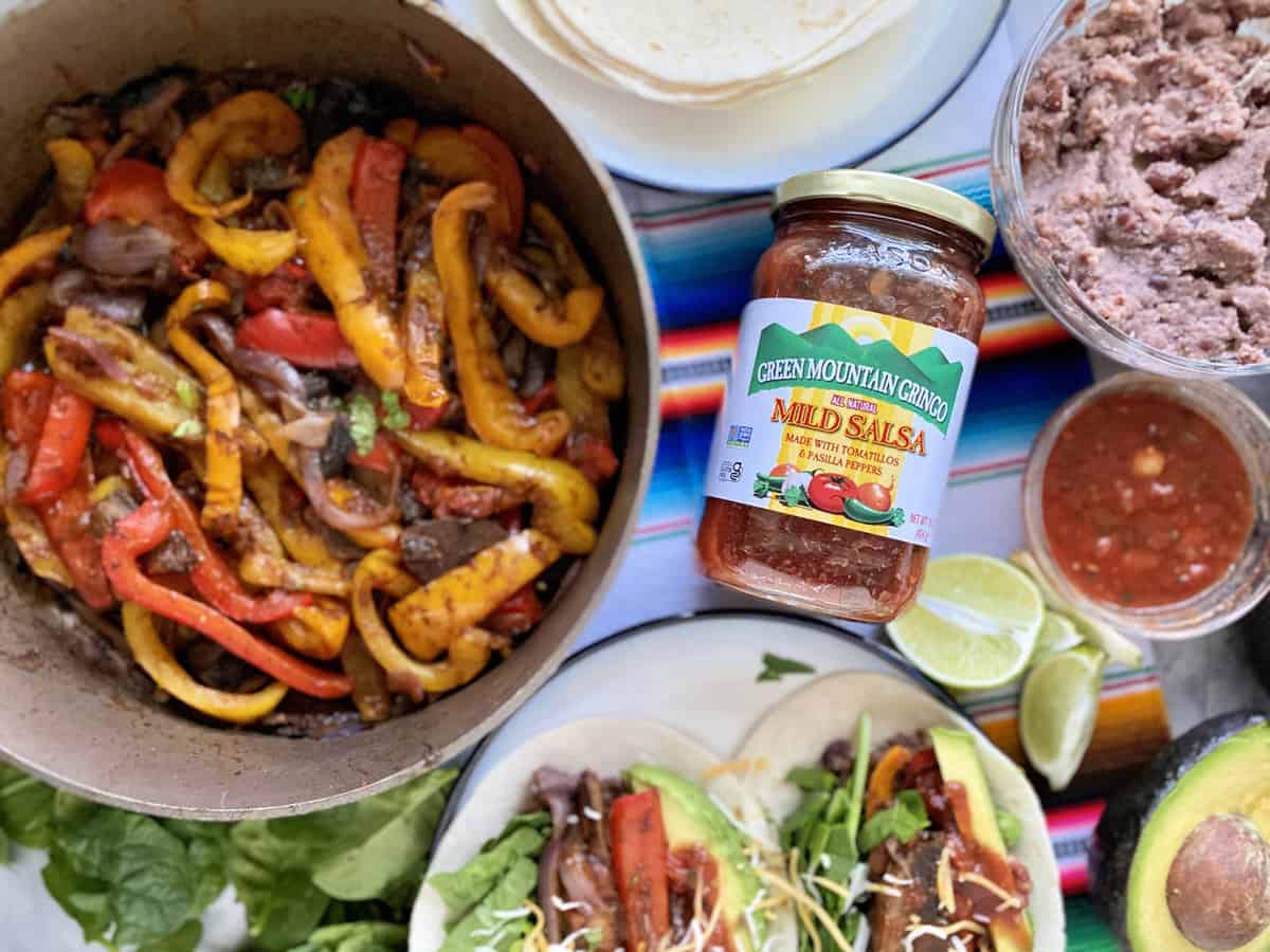 Green Mountain Gringo Salsa with fajita peppers and tacos around it.