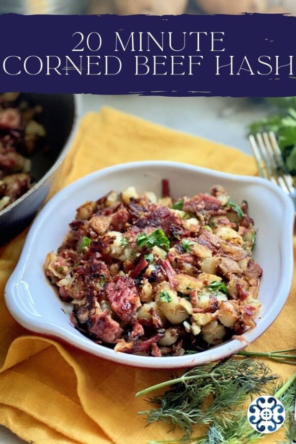 White bowl filled with potatoes, corned beef, and herb with text on image for Pinterest.