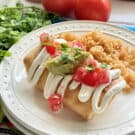 Fried Chicken Chimichanga on a white plate next to rice.