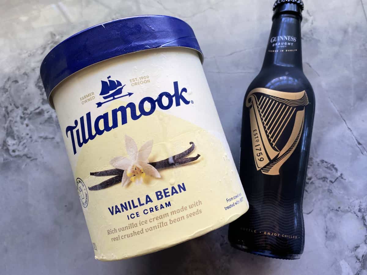 Two ingredients on marble countertop: vanilla ice cream and Guinness beer.