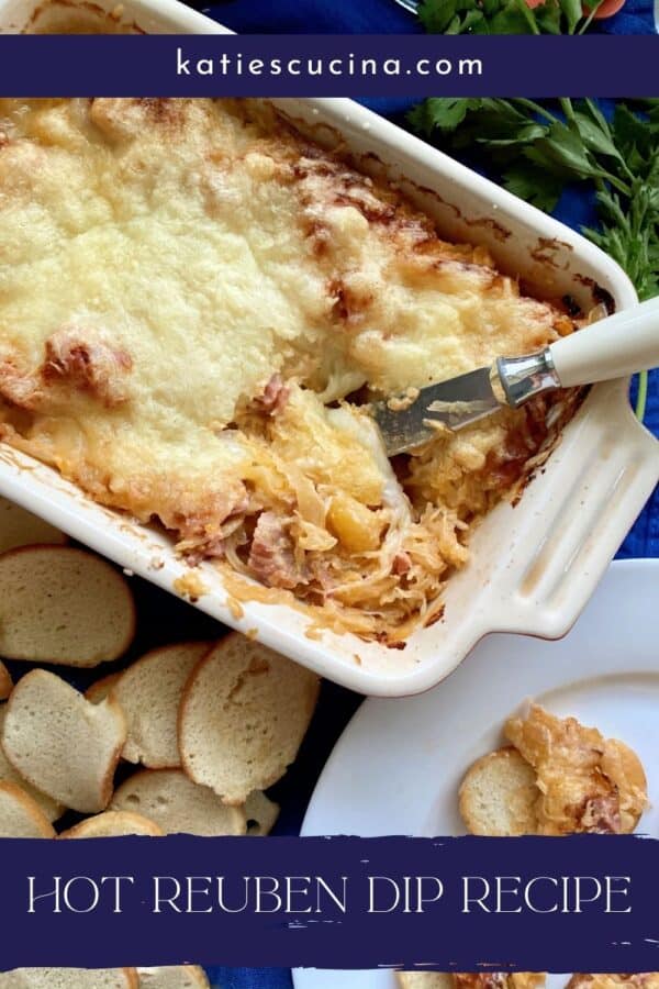 Top view of rectangular baking dish filled with dip and a spreading knife with text on image for Pinterest.